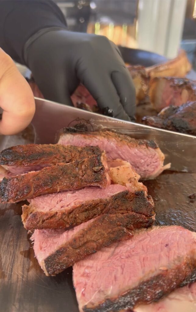 sliced grilled tomahawk on a cutting board