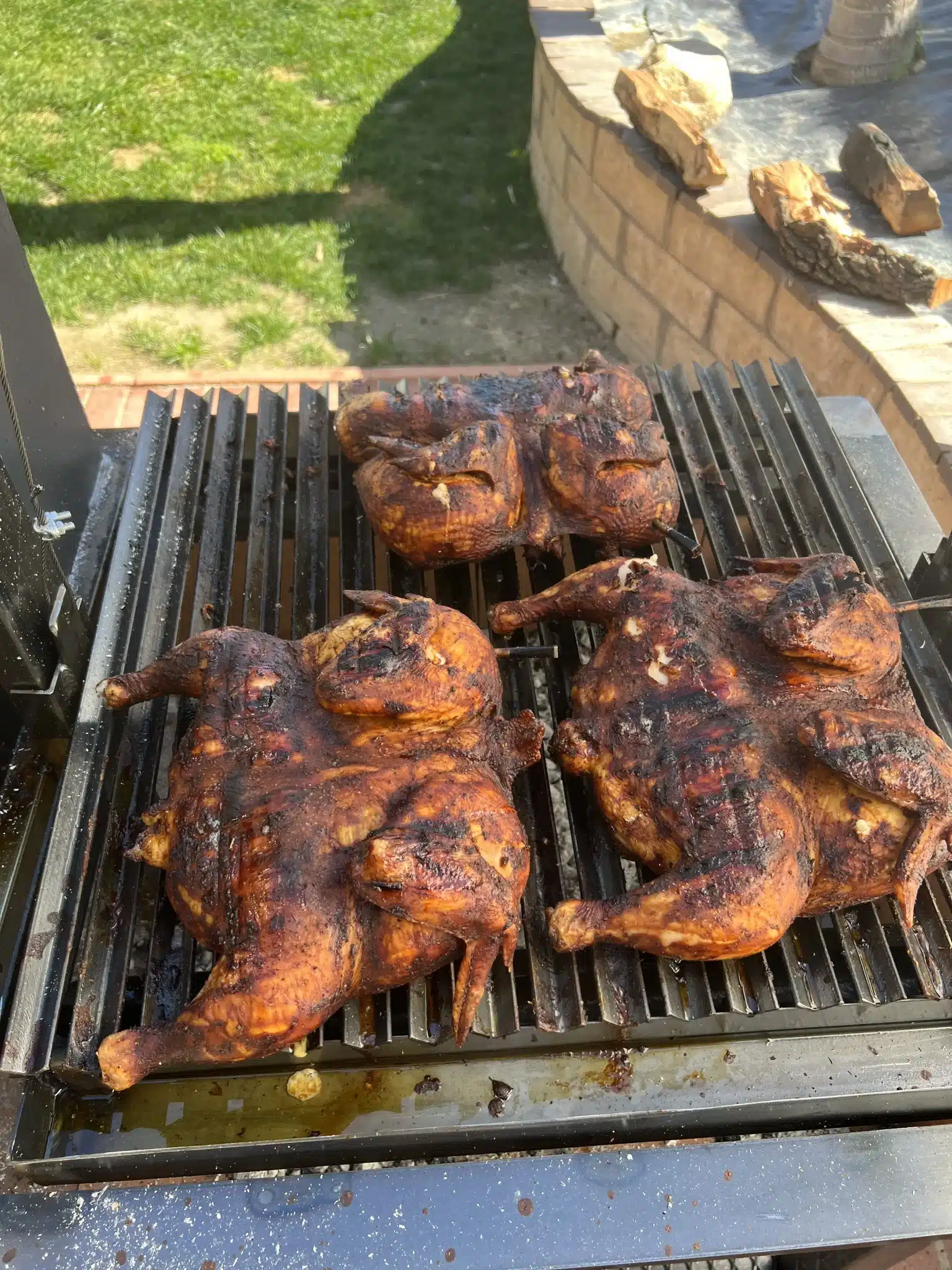 smoked chicken halves on the open fire grill