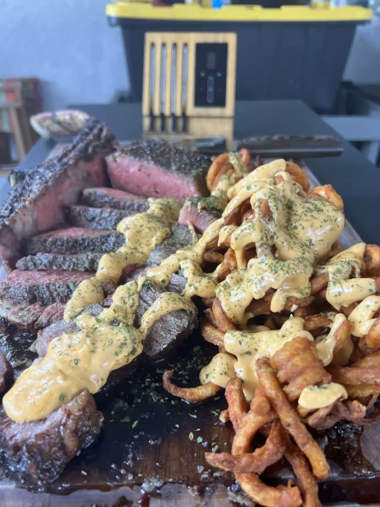 smoked tomahawk and curly cheese fries