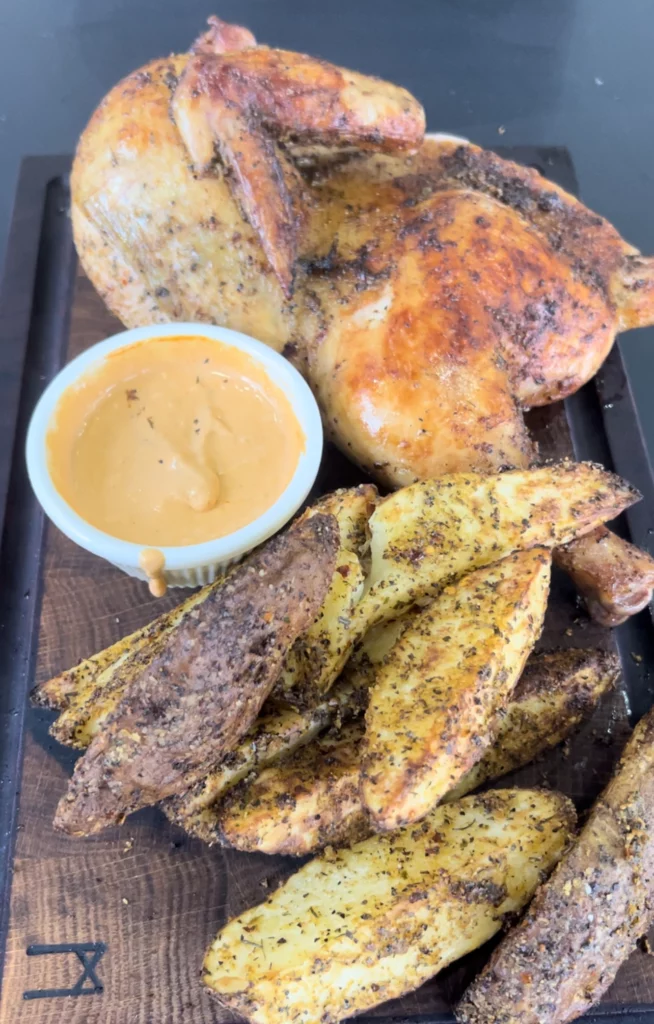 smoked chicken halves and potato wedges