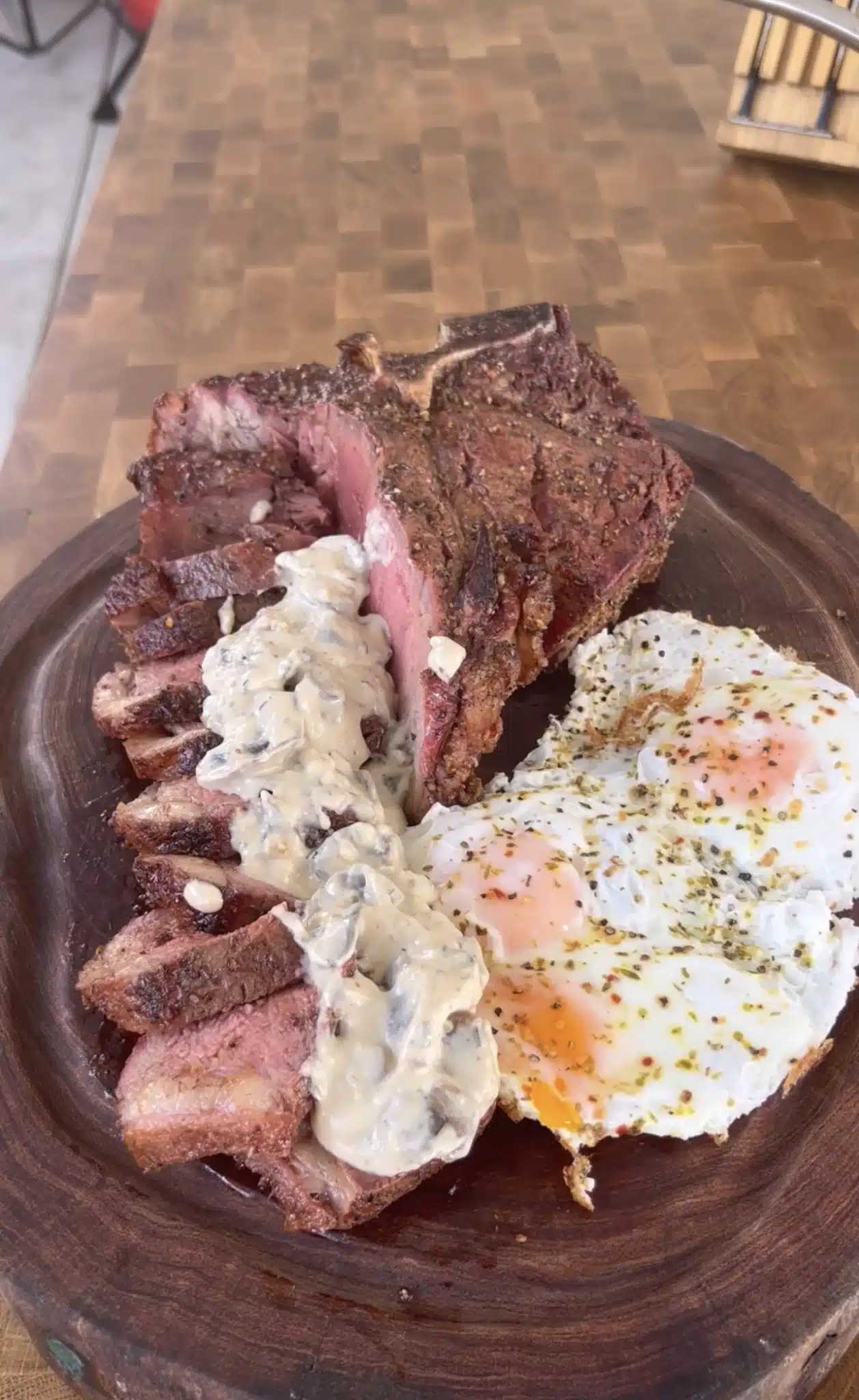 porterhouse with eggs and sauce