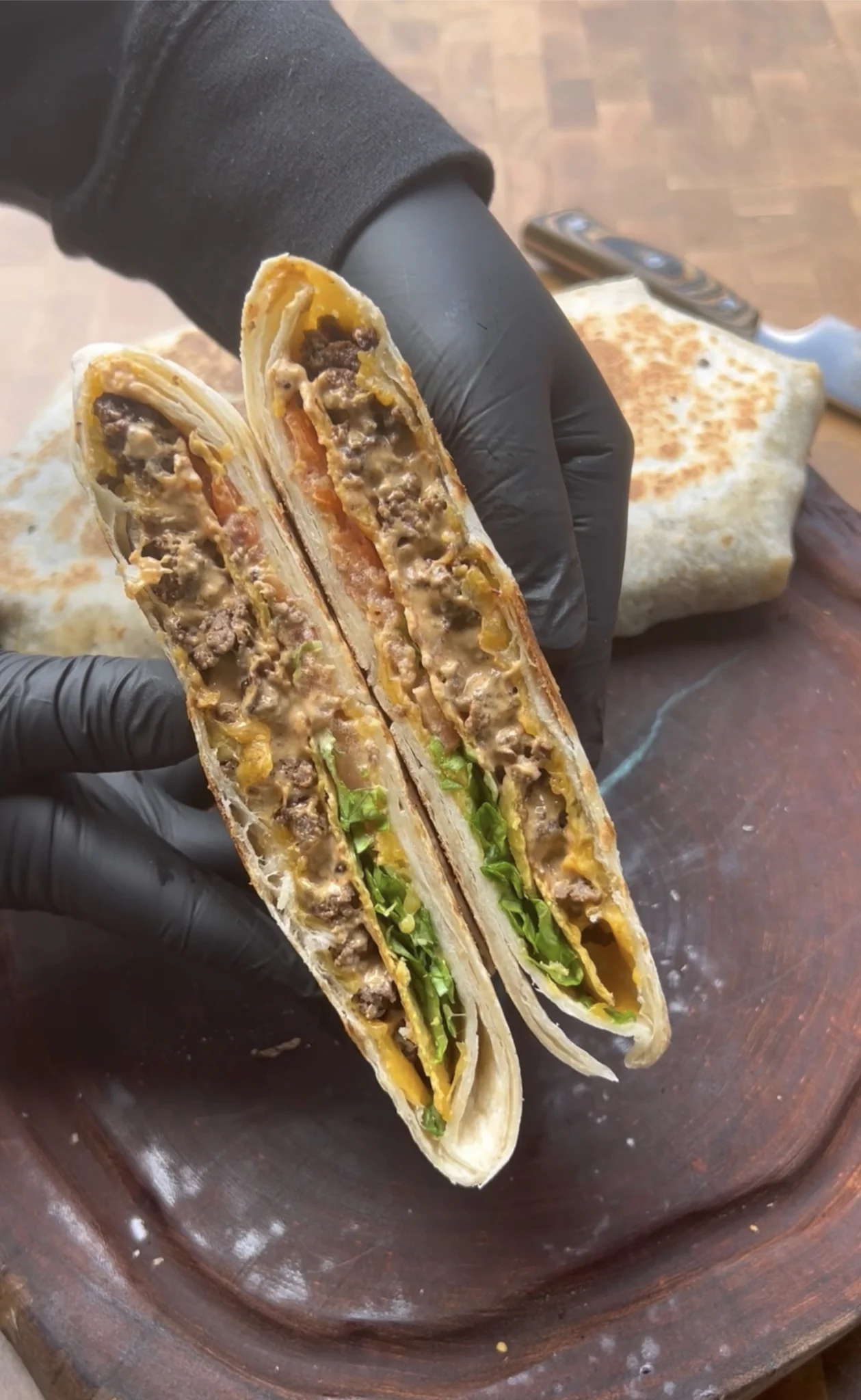 grilled crunchwrap recipe being held in hands