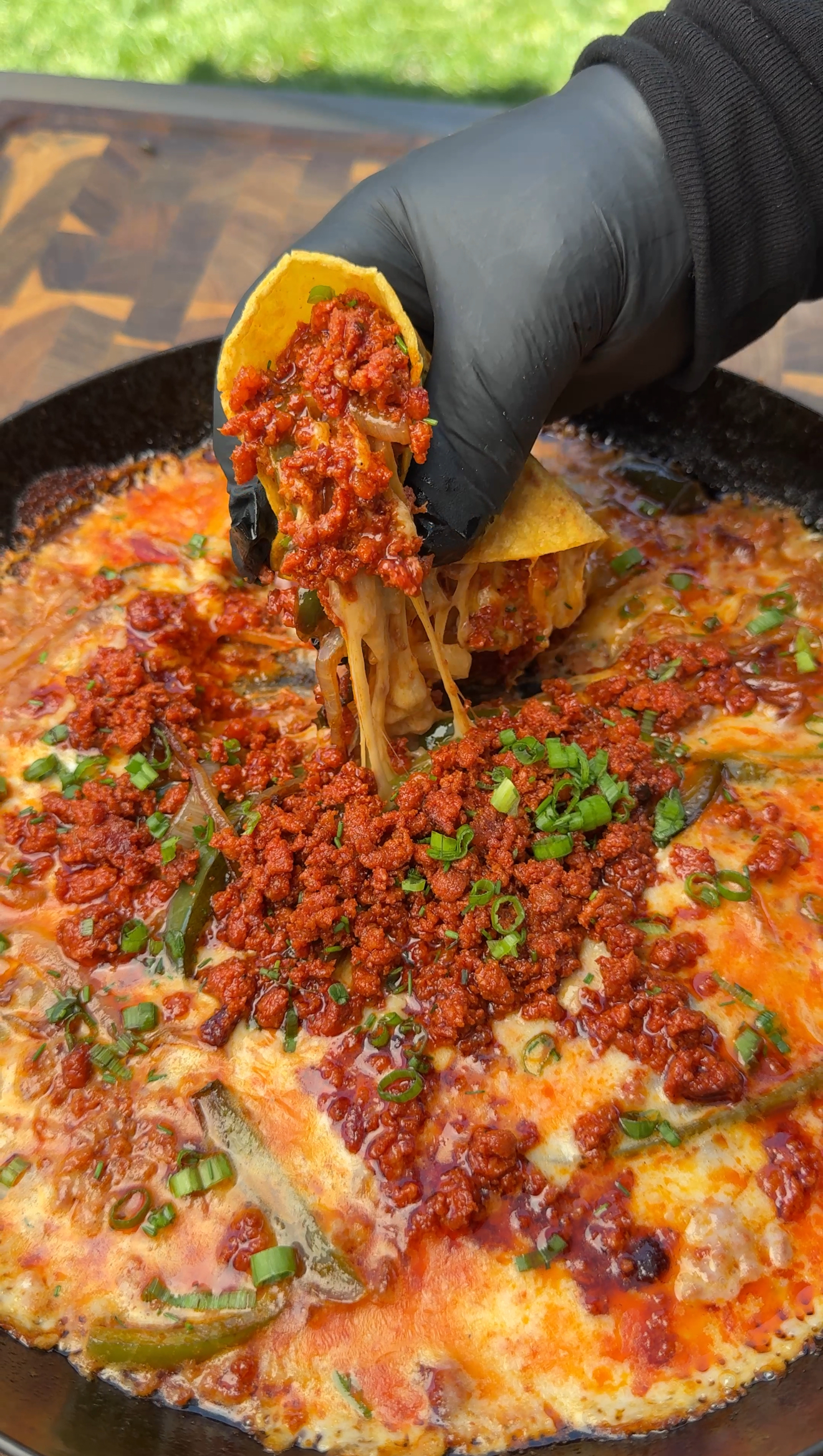 queso with a hand picking it up