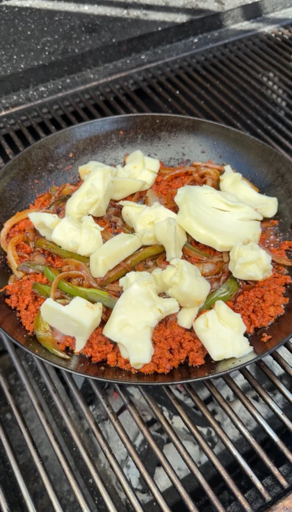 melting cheese over chorizo