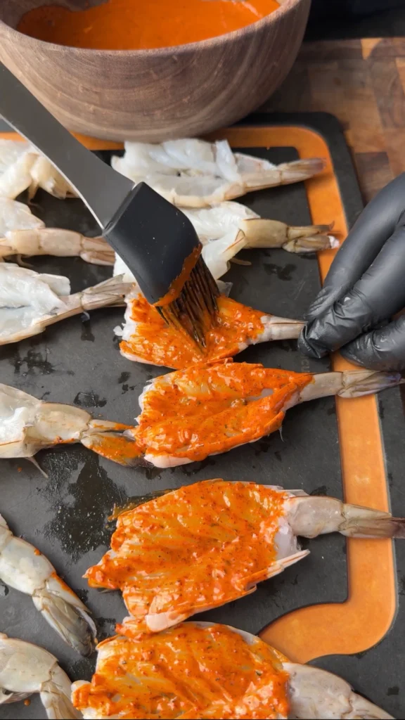 brushing sauce on shrimp