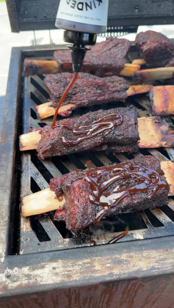 glazing the meat on the smoker