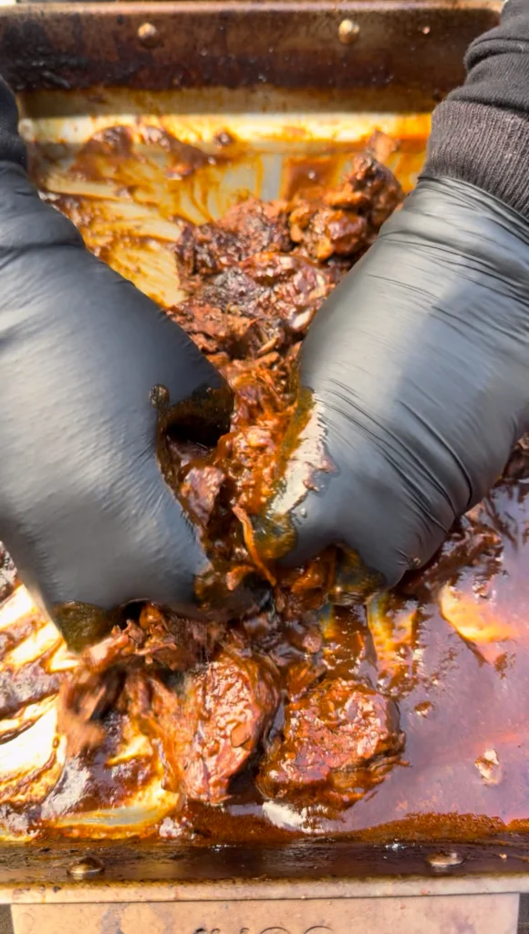 shredded beef in a pan for birria tacos