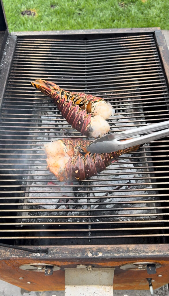 cajun honey grilled lobsters being grilled face down