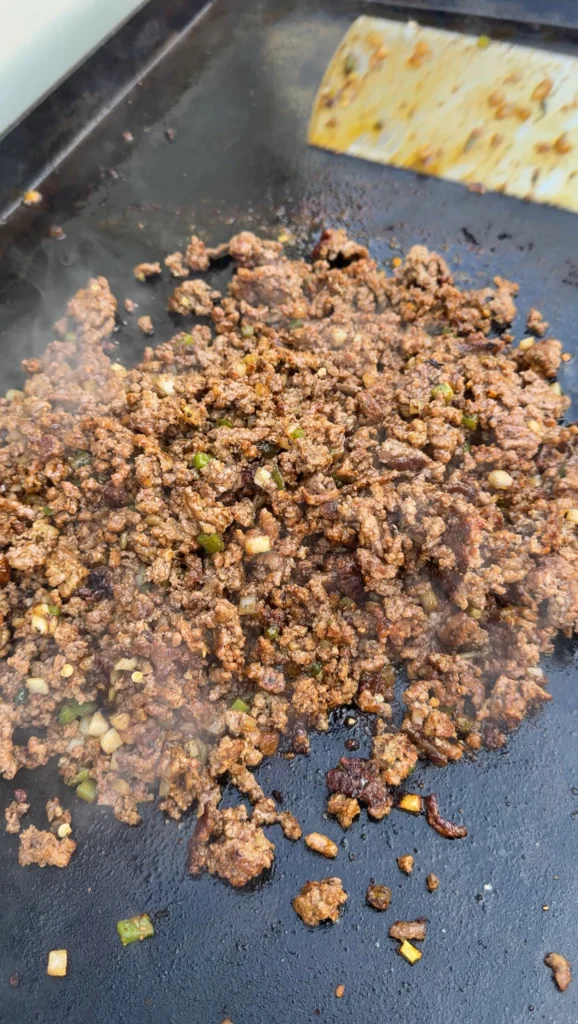 cooked ground beef on a flat top