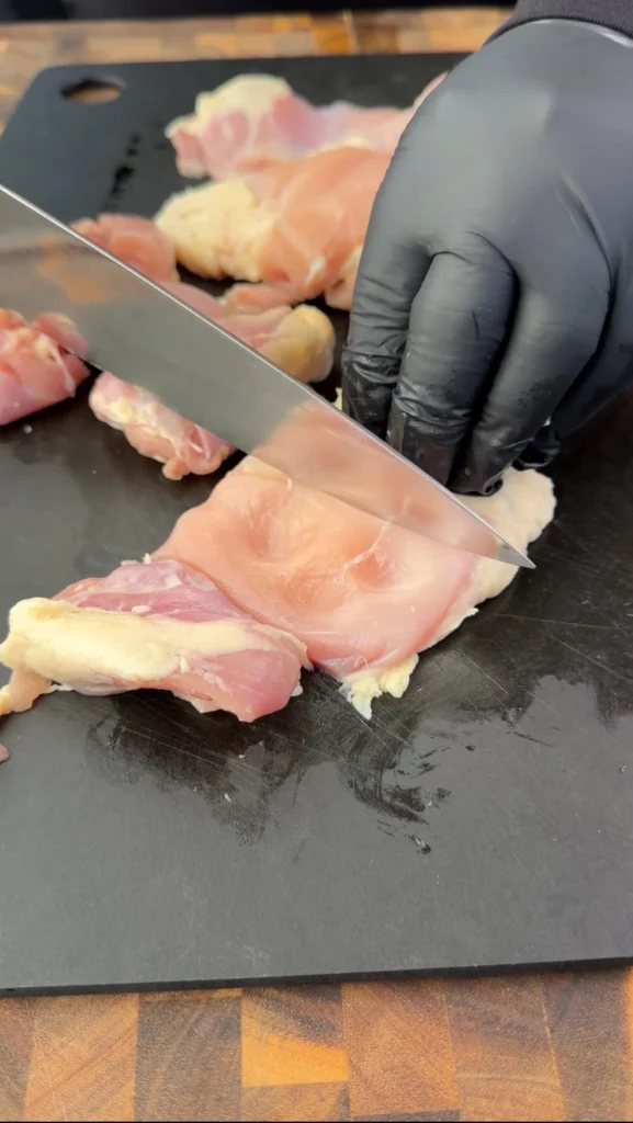 cutting up chicken thighs