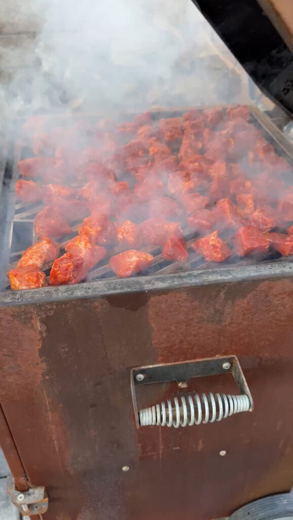 braising pork on a grill