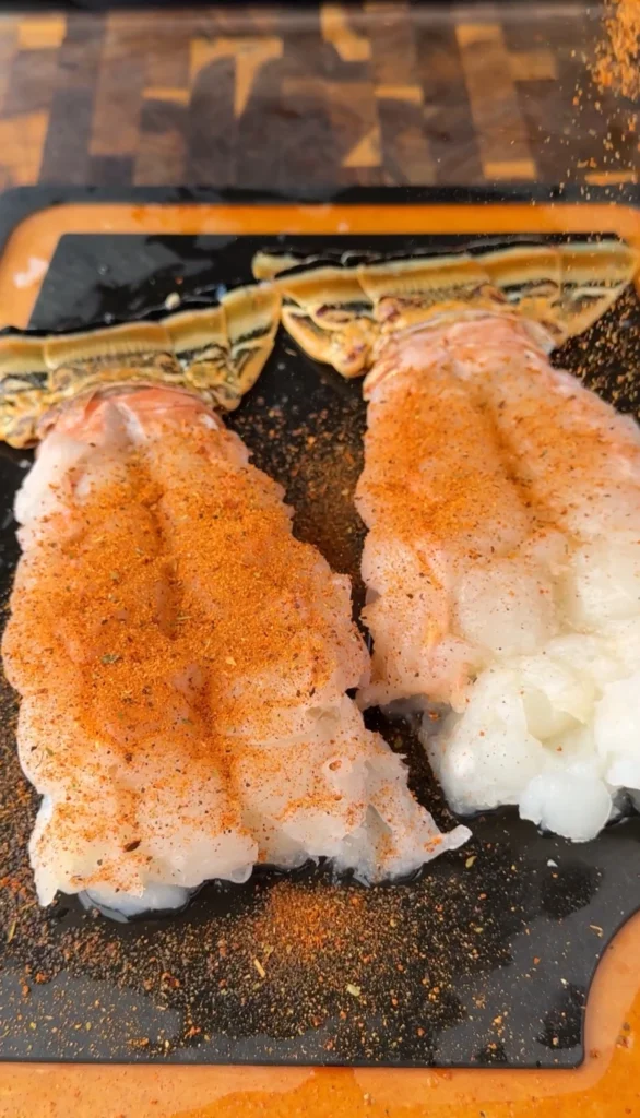 seasoned lobster on a cutting board