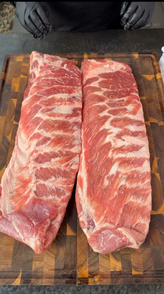 slabs of st louis style ribs on a cutting board