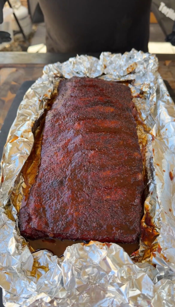 smoked ribs in the smoker with aluminum foil