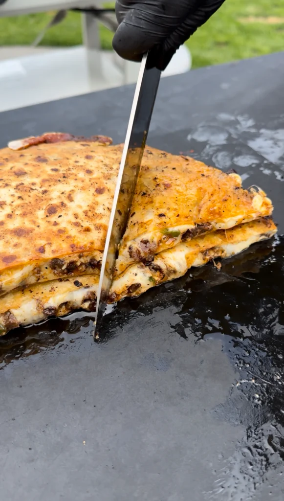 sliced quesadilla on a griddle
