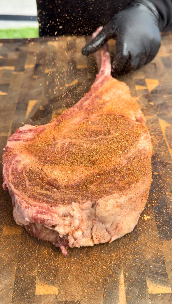 seasoned ribeye on a cutting board