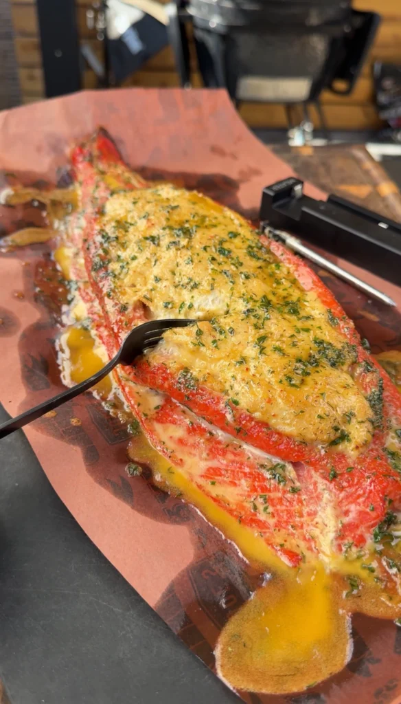Salmon fillet filled with crab mixture and seasoned, smoking over mild wood.