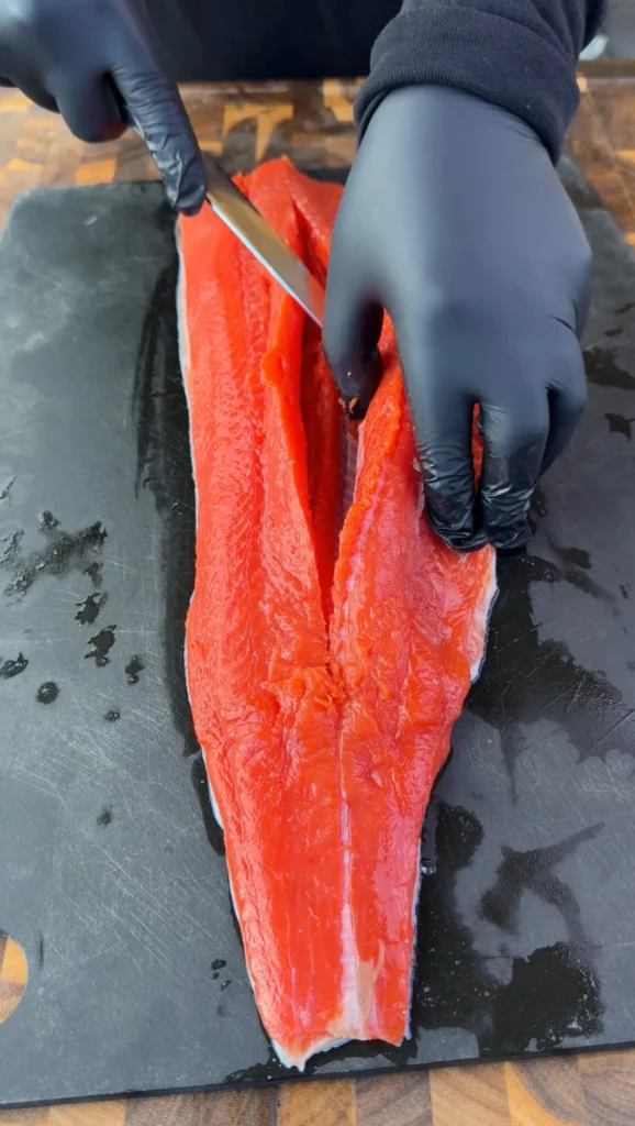 opened salmon filet on a cutting board