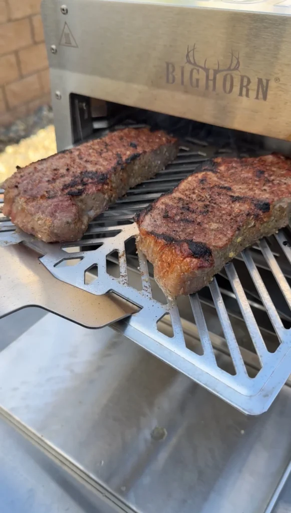 cooked steaks on the grill