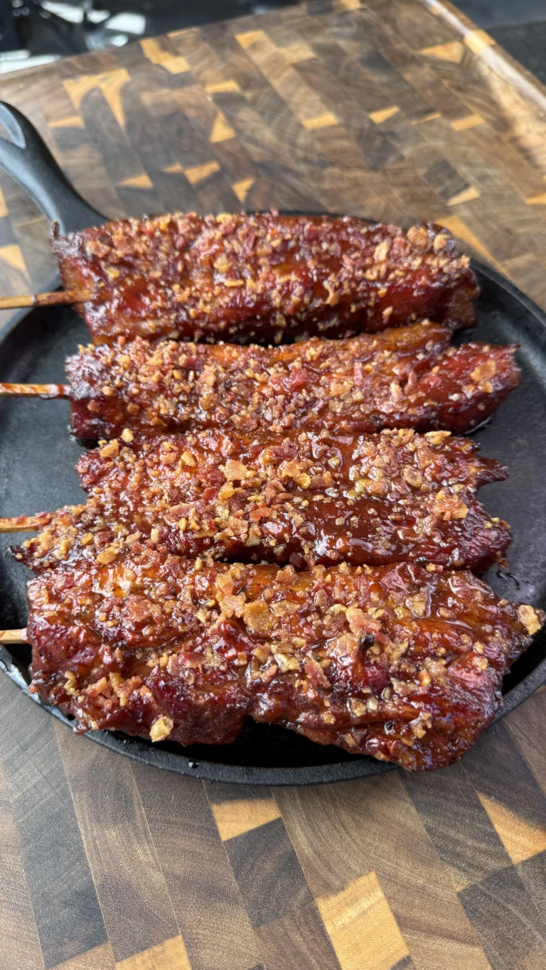 pork belly on a stick on a cutting board