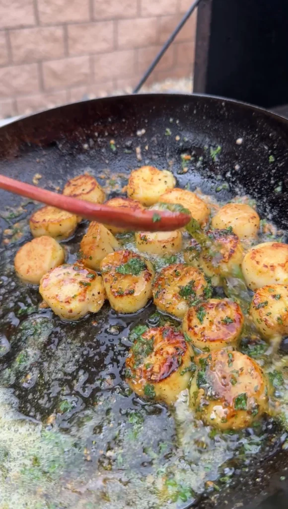 lemon pepper butter scallops in a cast iron