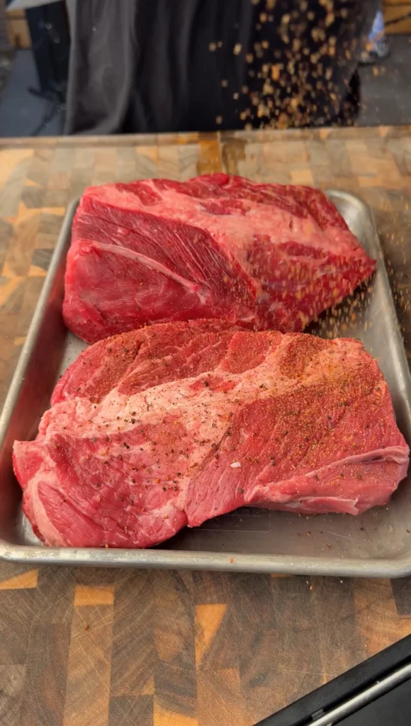 seasoned chuck roast on a silver pan