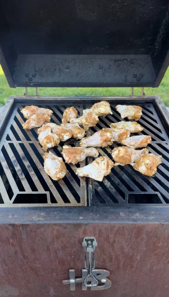 chicken wings on the grill grates