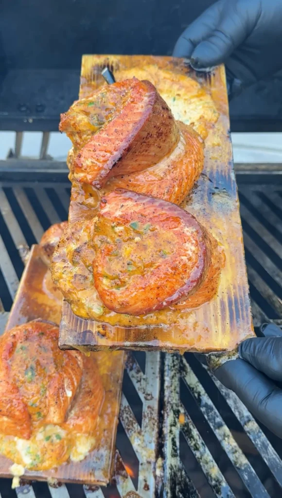 smoked salmon pinwheels on a cedar plank