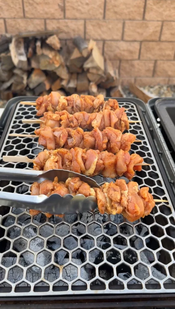 chicken skewers on the grill grates