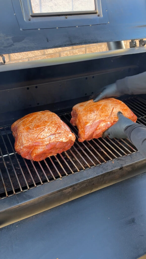 two pork shoulders on the smoker