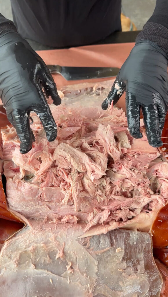 shredded pork in a pan from the whole pig