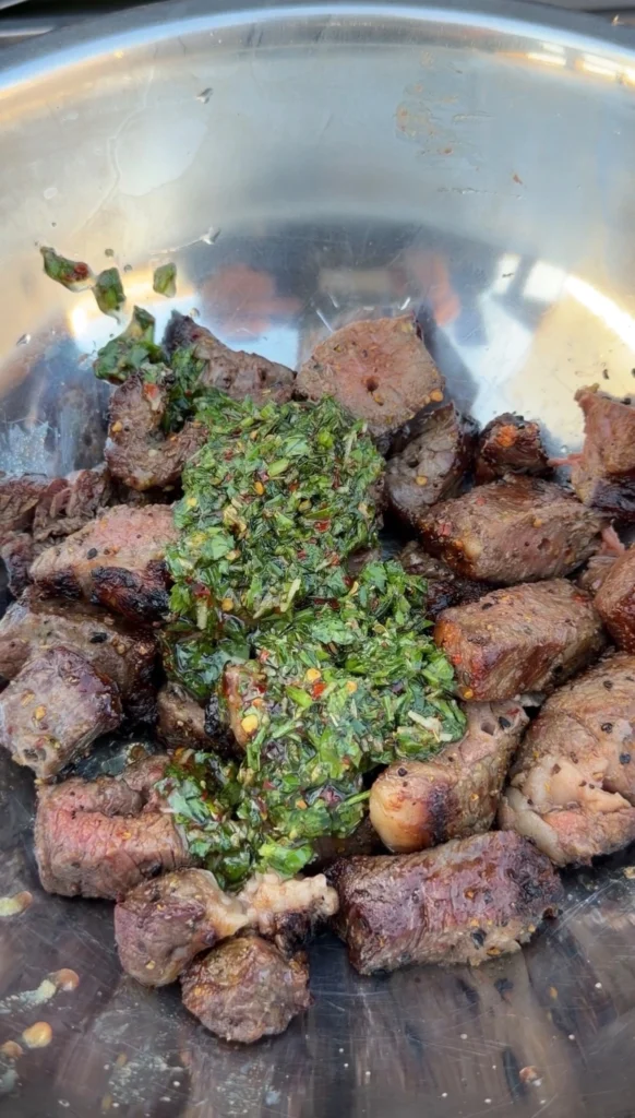 chimichurri on the steak bites in a bowl