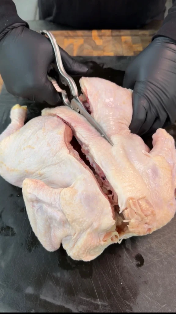 cutting the spine out of the chicken
