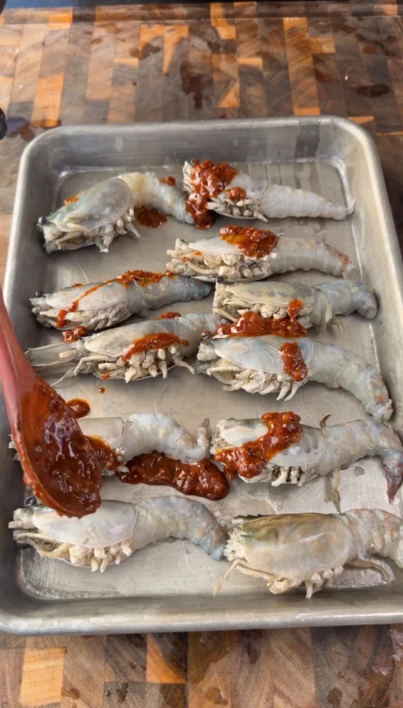 adding sauce to the prawns