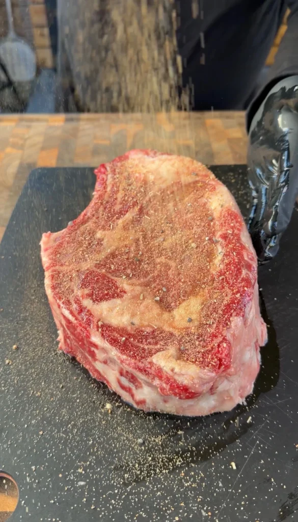 seasoning on the cowboy steak