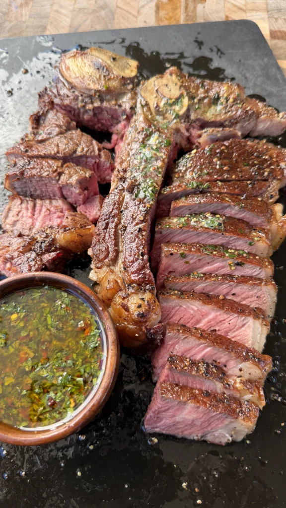 seared ribeye on a black cutting board