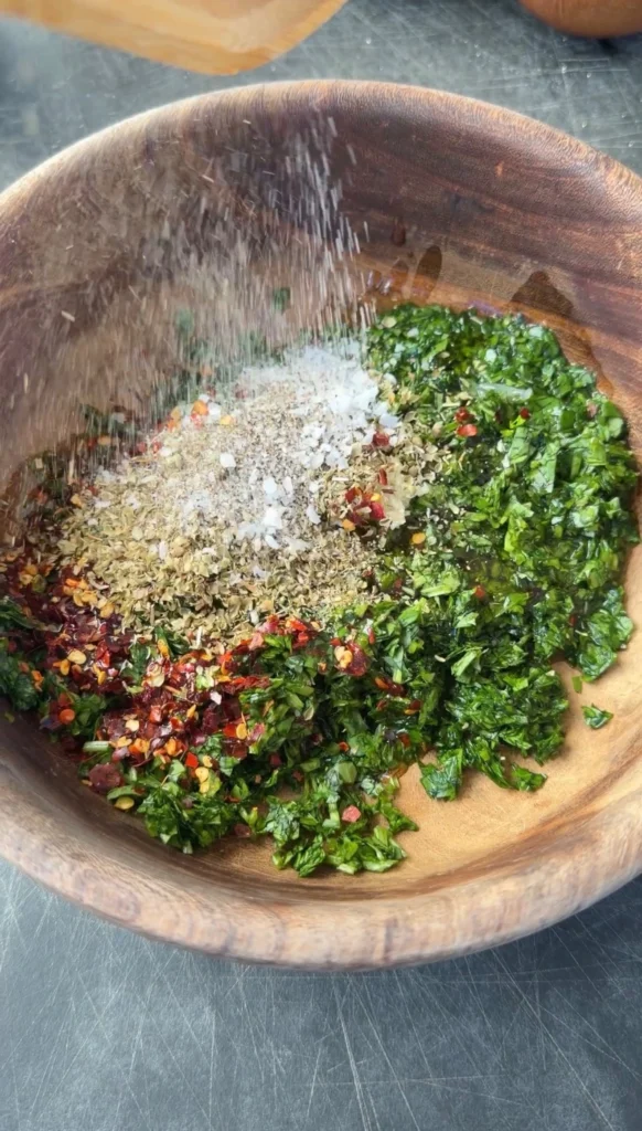 chimichurri n ingredients in a wooden bowl
