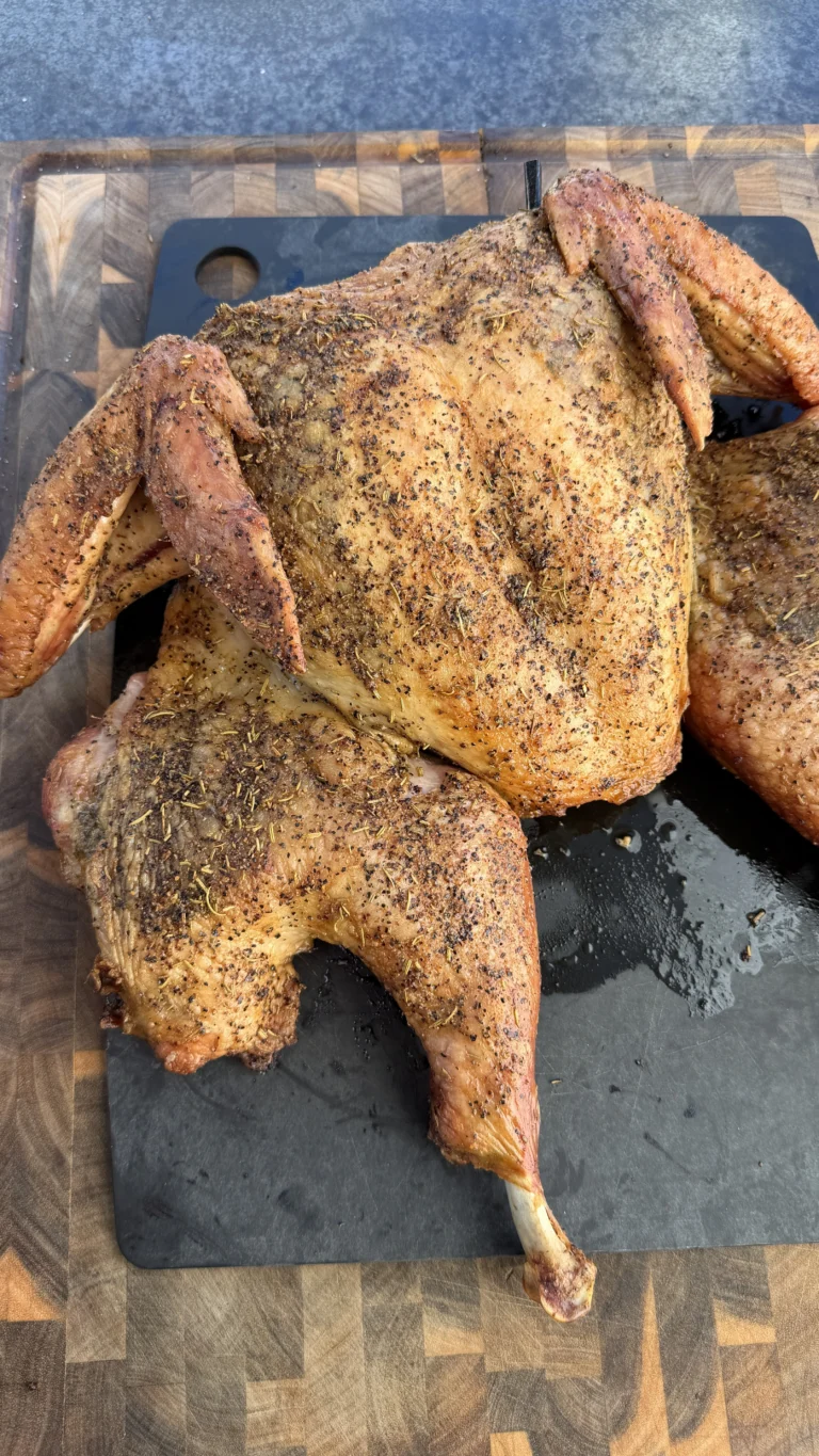 smoked whole turkey on a cutting board
