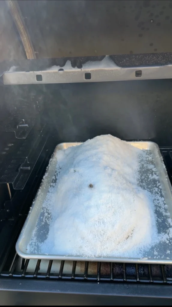 salt covered tenderloin in the smoker