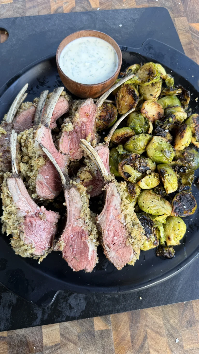 herb crusted lamb on a black plate