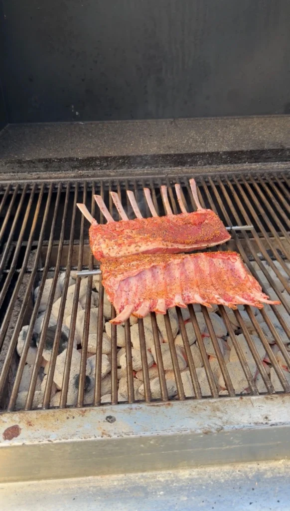 grilled rack of lamb over a charcoal grill