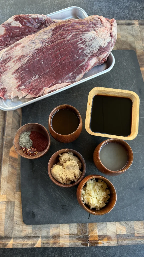 flank steak ingredients on a black cutting board