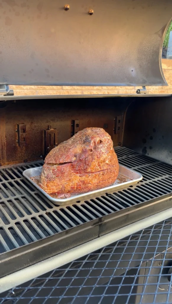 ham on the smoker with a meat probe in it