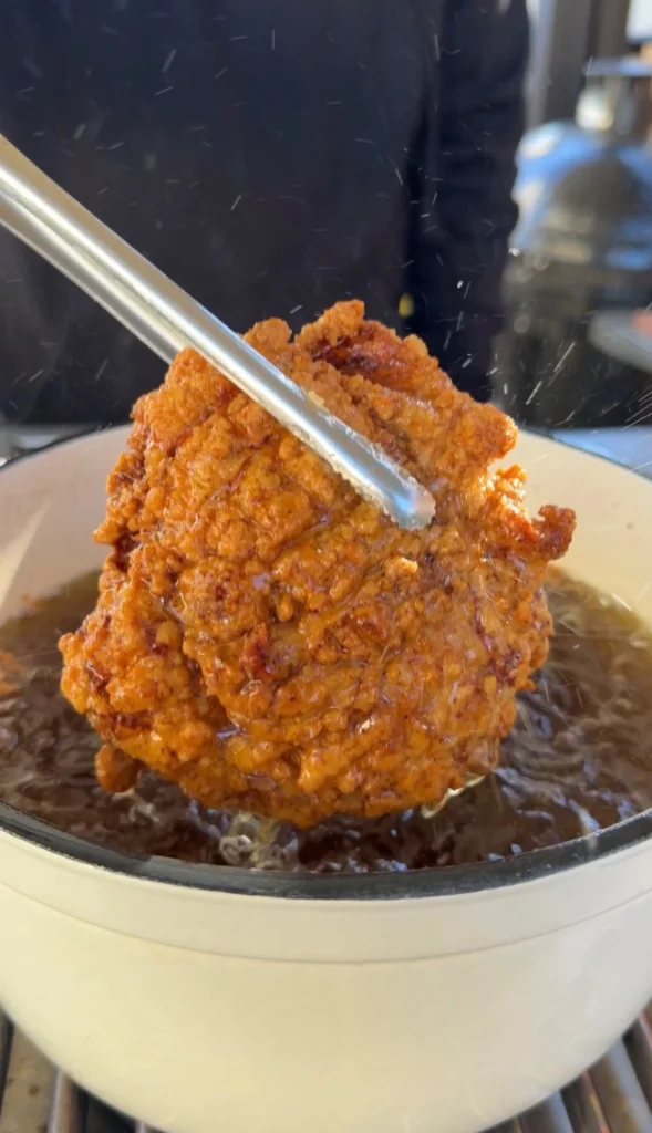 perfect fried chicken in a bowl of glaze