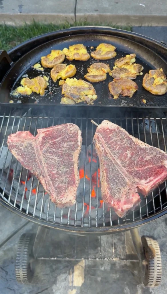 grilled steaks with potatoes in the back