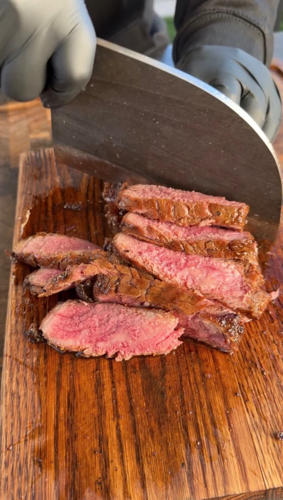sliced strip steak on a cutting board