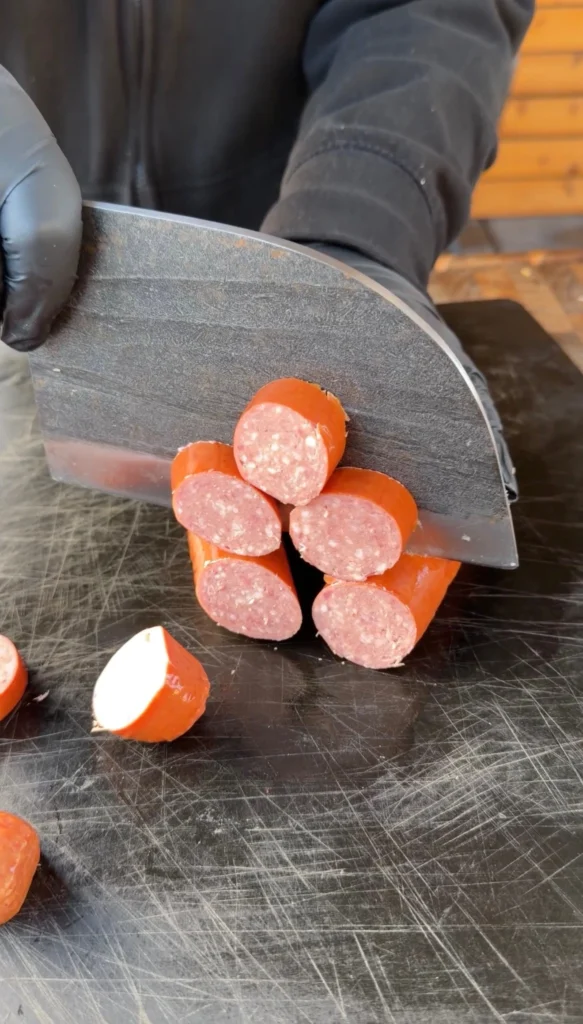 sliced sausage on a cutting board for pig shots
