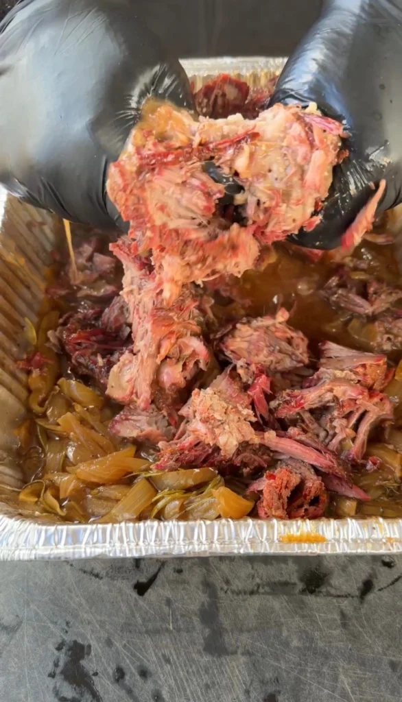 shredded beef in a metal pan
