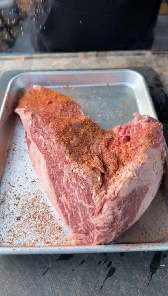 seasoned tri tip on a metal tray