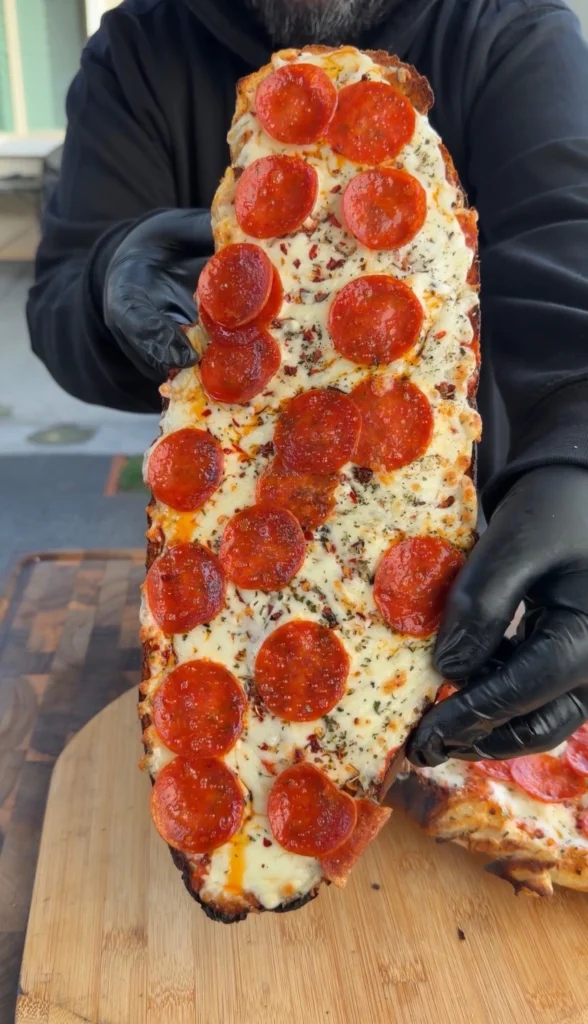 hot honey pizza being held upright